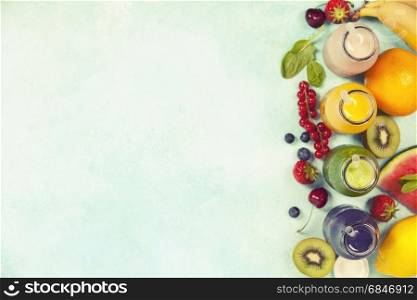 Fresh juices or smoothies with fruits and vegetables on blue background, top view, selective focus. Detox, dieting, clean eating, vegetarian, vegan, fitness, healthy lifestyle concept