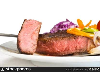 fresh juicy beef ribeye steak sliced ,with lemon and orange peel on top and vegetable beside