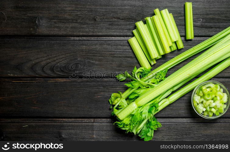 Fresh juicy celery in a bowl. On wooden background. Fresh juicy celery in a bowl.