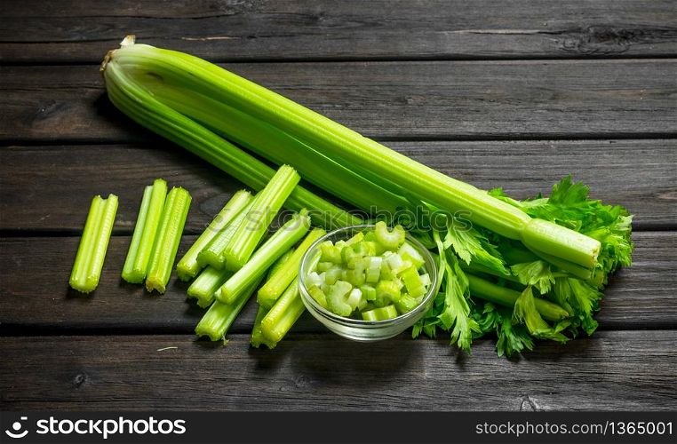 Fresh juicy celery in a bowl. On wooden background. Fresh juicy celery in a bowl.