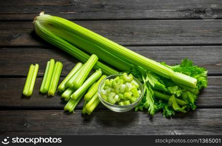 Fresh juicy celery in a bowl. On wooden background. Fresh juicy celery in a bowl.