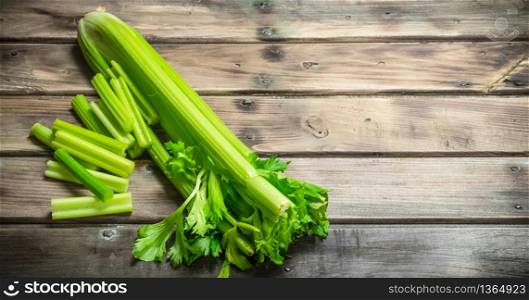 Fresh juicy celery. On wooden background. Fresh juicy celery.