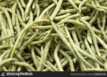 Fresh juicy green beans on a counter in the market of India of Goa. Fresh juicy green beans on a counter in the market of India of Goa.