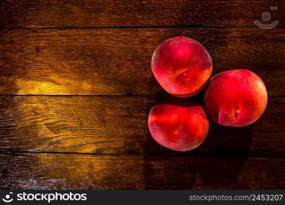 Fresh juicy peaches on rustic wooden table