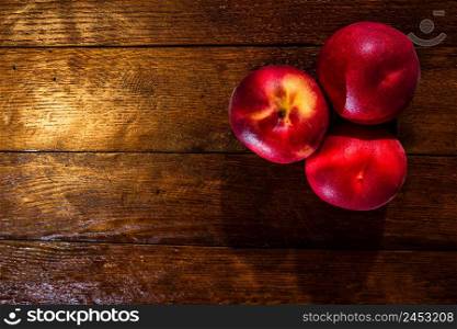 Fresh juicy peaches on rustic wooden table
