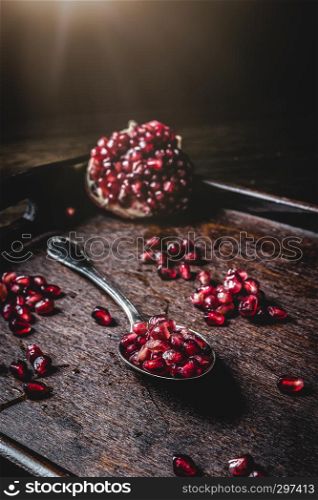 Fresh juicy pomegranate on a wooden vintage background, top view, horizontal, with copy space