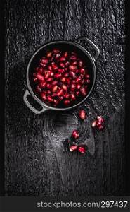 fresh juicy pomegranate on a wooden vintage background, top view, horizontal, with copy space