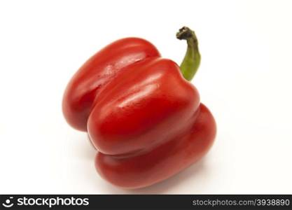Fresh juicy red sweet pepper close up on a white background.. Fresh juicy red sweet pepper close up on a white background