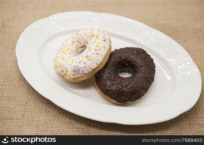 Fresh juicy sweet pastries donuts on a dark background.. Fresh juicy sweet pastries donuts on a dark background