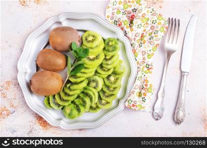 fresh kiwi on metal plate, juice kiwi