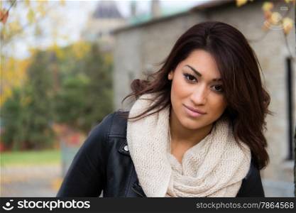 Fresh Latino woman posing outdoors during autumn
