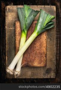 fresh Leek on cutting board and wooden table , top view