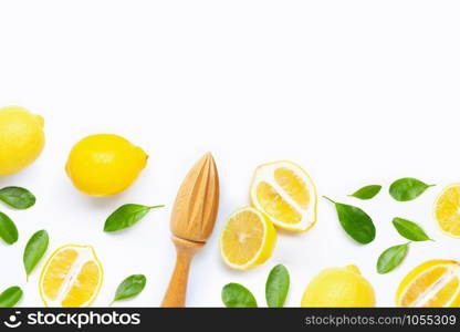 Fresh lemon and leaves with wooden juicer on white background.