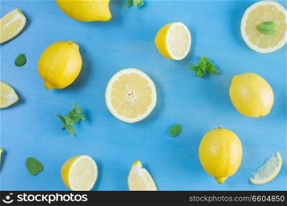 Fresh lemon citrus fruits slices pattern on blue bakground. Fresh lemon fruits