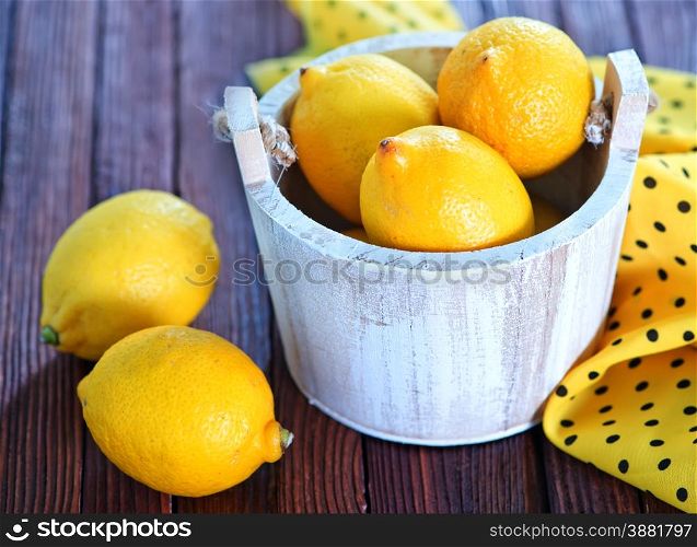 fresh lemon on the wooden table, lemons on wooden background