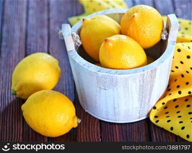 fresh lemon on the wooden table, lemons on wooden background