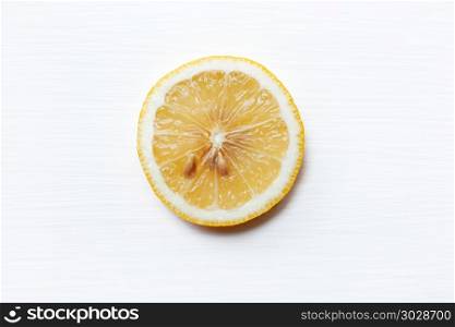 Fresh lemon slice on white.. Fresh lemon slice on a white background.