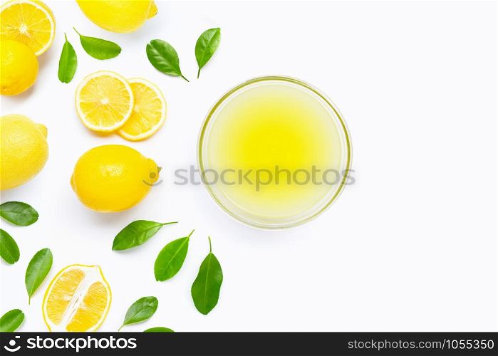 Fresh lemon with bowl of freshly squeezed lemon juice on white background. Copy space
