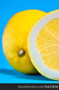 fresh lemon with cut isolated on blue background
