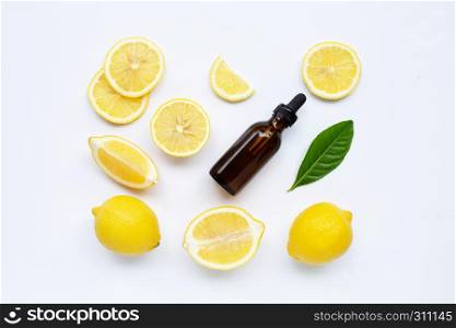Fresh lemon with lemon essential oil on a white background.