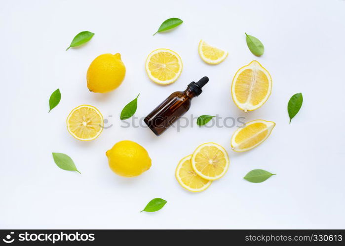 Fresh lemon with lemon essential oil on a white background.