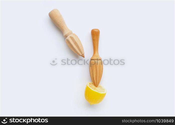 Fresh lemon with two wooden juicer on white background. Copy space