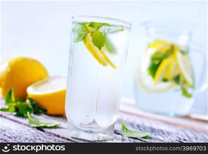 fresh lemonad in glass and on a table
