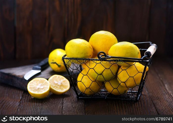 fresh lemons in basket and on a table