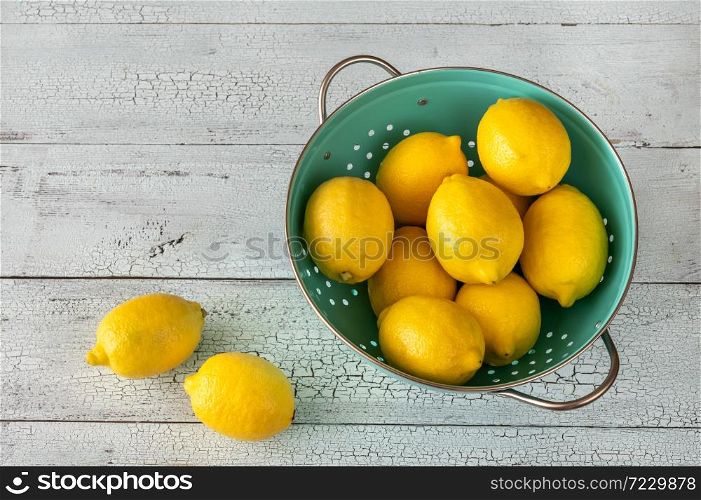 Fresh lemons in the colander: top view