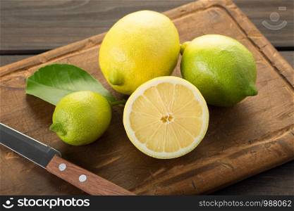 Fresh lemons on wooden cutting board