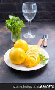 fresh lemons with mint leaves on a table