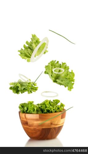 fresh lettuce and onion salad floating of the bowl