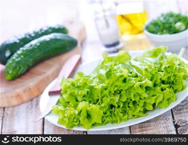 fresh lettuce on plate and on a table