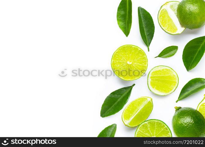 Fresh limes and leaves on white background. Copy space