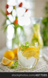 Fresh limes and lemonade on table