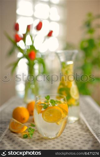 Fresh limes, mint and lemonade on table