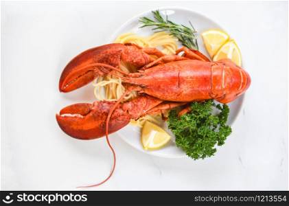 Fresh lobster food on a white plate background / red lobster dinner seafood with herb spices lemon rosemary served table in the restaurant gourmet food healthy boiled lobster cooked salad