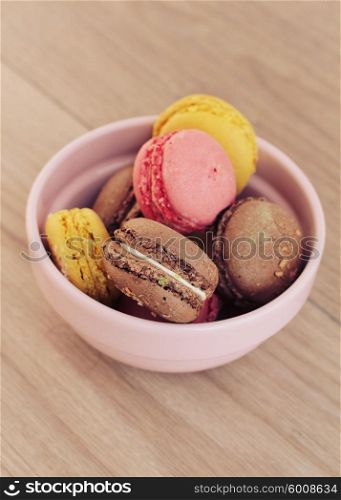 Fresh macarons on a pink bowl