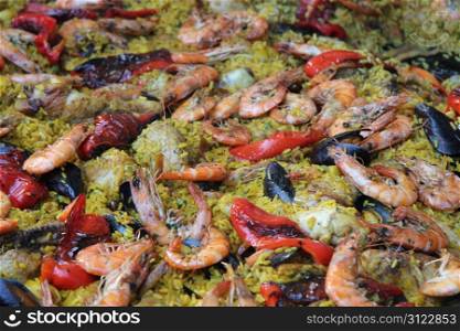 Fresh made paella with rice and seafood at a French market