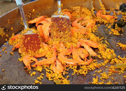 Fresh made paella with rice and seafood at a French market