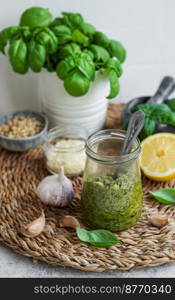 Fresh made Pesto sauce. Green basil pesto.  Ingredient for pesto sauce - Fresh Basil, Pine Nuts, Olive Oil and Cheese