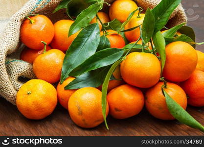 fresh mandarin oranges fruit with leaves on wooden table