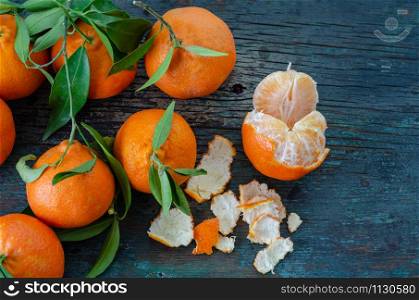 Fresh mandarins and leaf on the wooden table,top view.