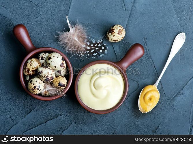fresh mayonnaise sauce in bowl and on a table