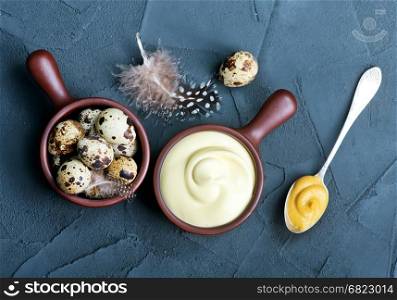 fresh mayonnaise sauce in bowl and on a table