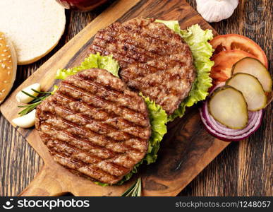 Fresh meat cutlets on wooden background. Fresh meat cutlets