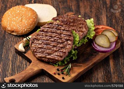Fresh meat cutlets on wooden background. Fresh meat cutlets