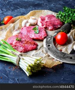 Fresh meat home beef. Sliced fresh juicy veal steaks with wild garlic and tomatoes