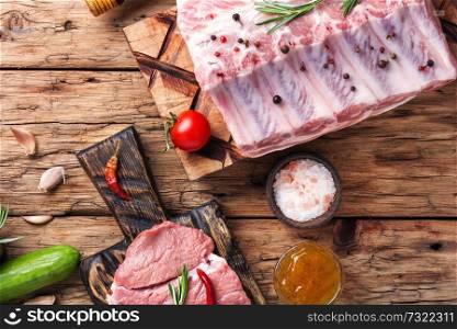 Fresh meat.Raw meat.Different types of raw meat on a wooden background. Raw meat on wooden board