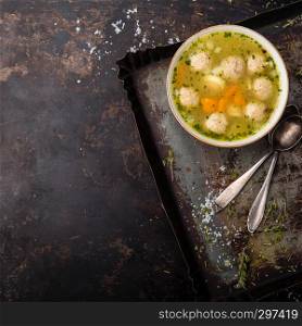 Fresh meat soup in bowl on dark background, top view